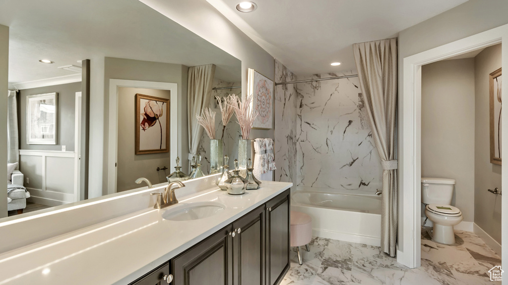 Full bathroom featuring vanity, shower / bath combo, toilet, ornamental molding, and tile floors