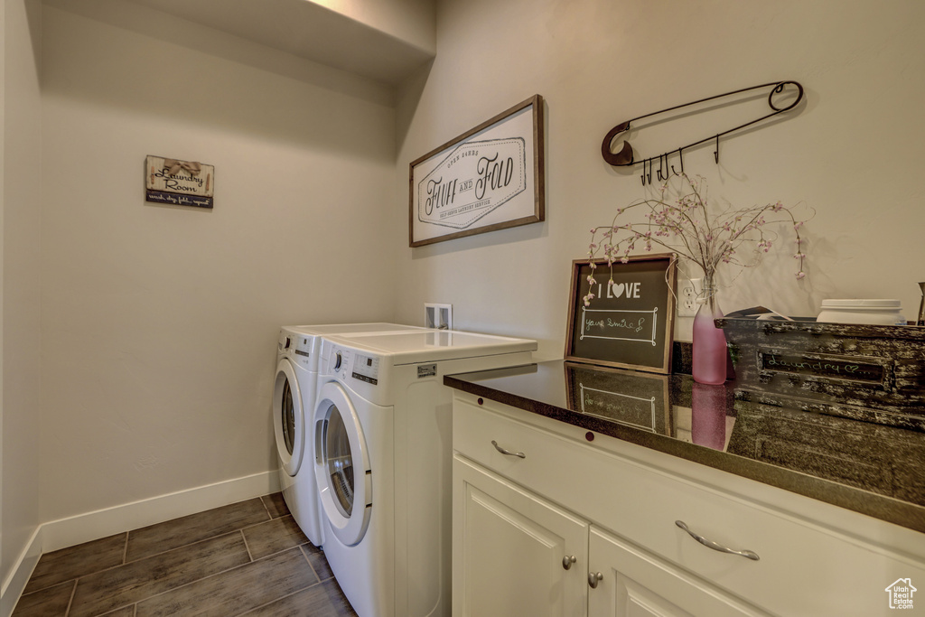Laundry area featuring washer hookup, washing machine and clothes dryer, and cabinets