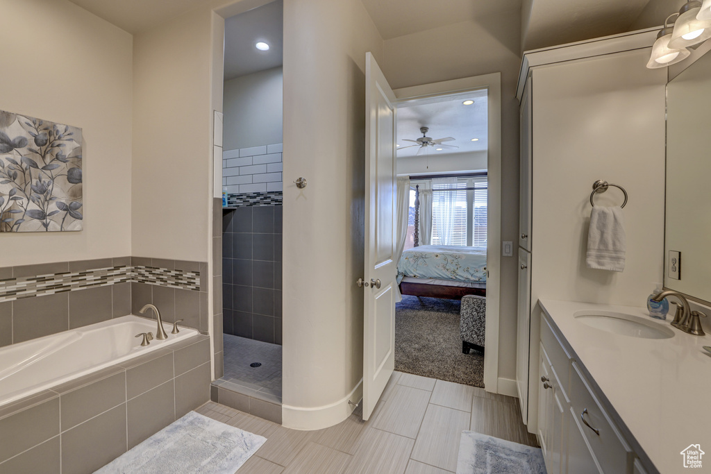 Bathroom featuring tile flooring, independent shower and bath, vanity, and ceiling fan