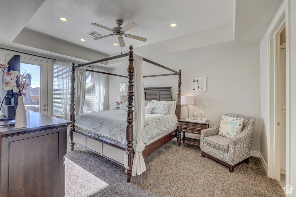Carpeted bedroom featuring a raised ceiling, french doors, access to exterior, and ceiling fan