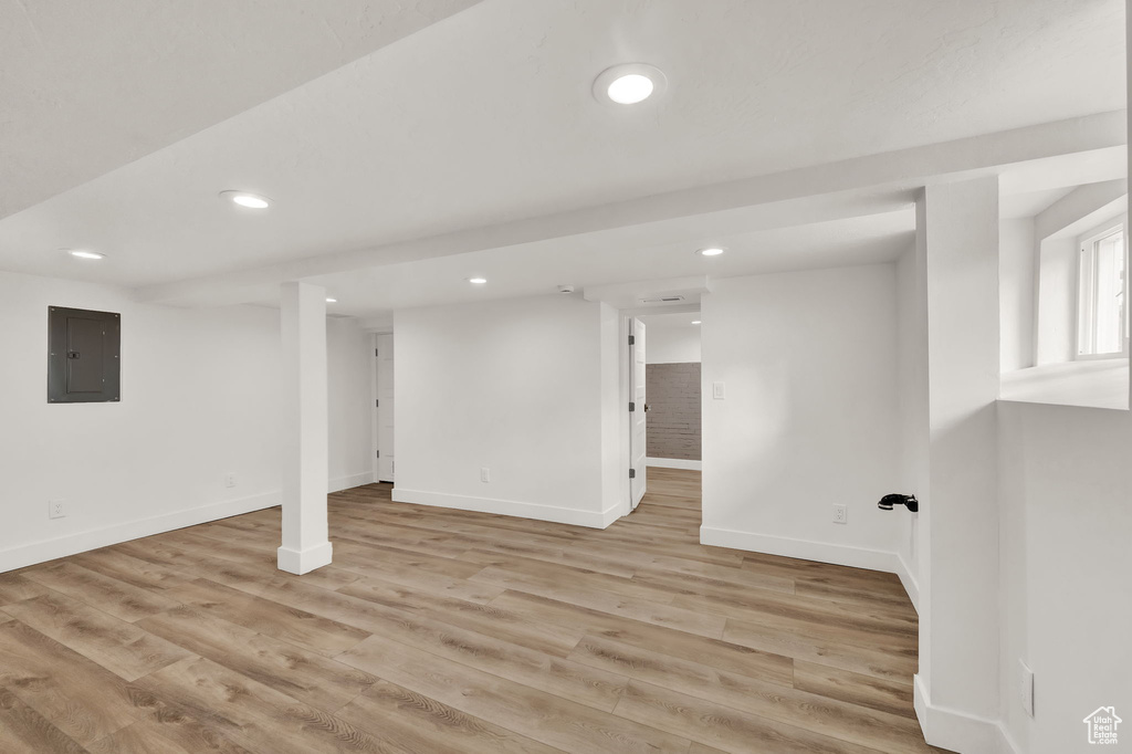 Basement with light hardwood / wood-style floors