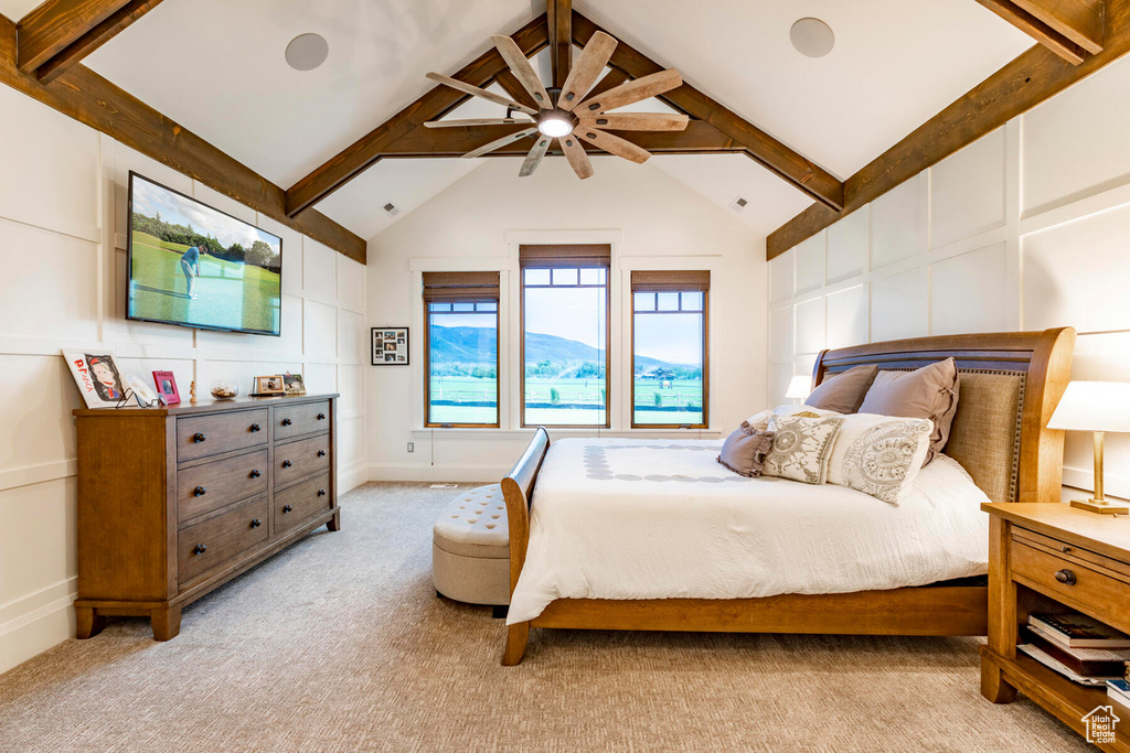 Bedroom featuring a mountain view, light carpet, ceiling fan, and lofted ceiling with beams