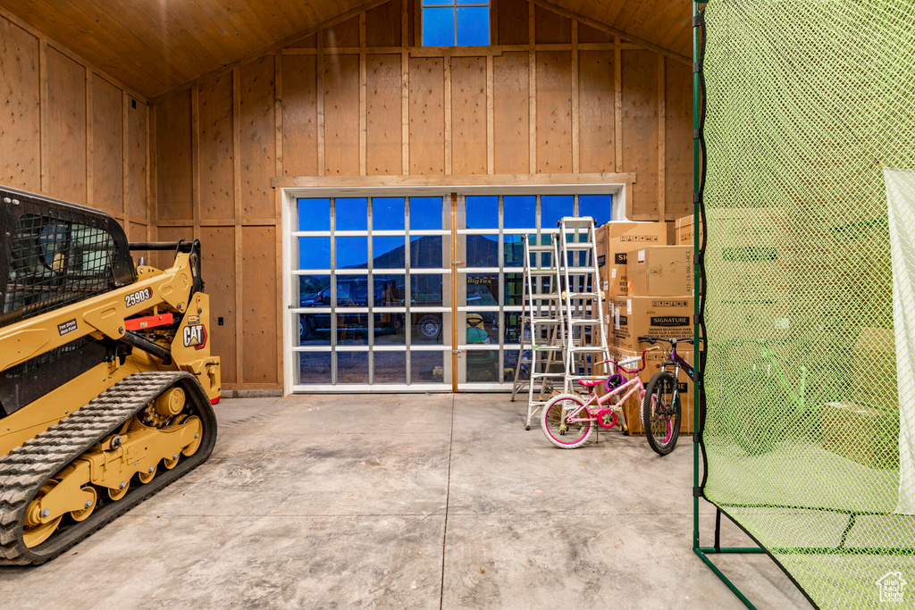 Garage featuring wood walls and wooden ceiling