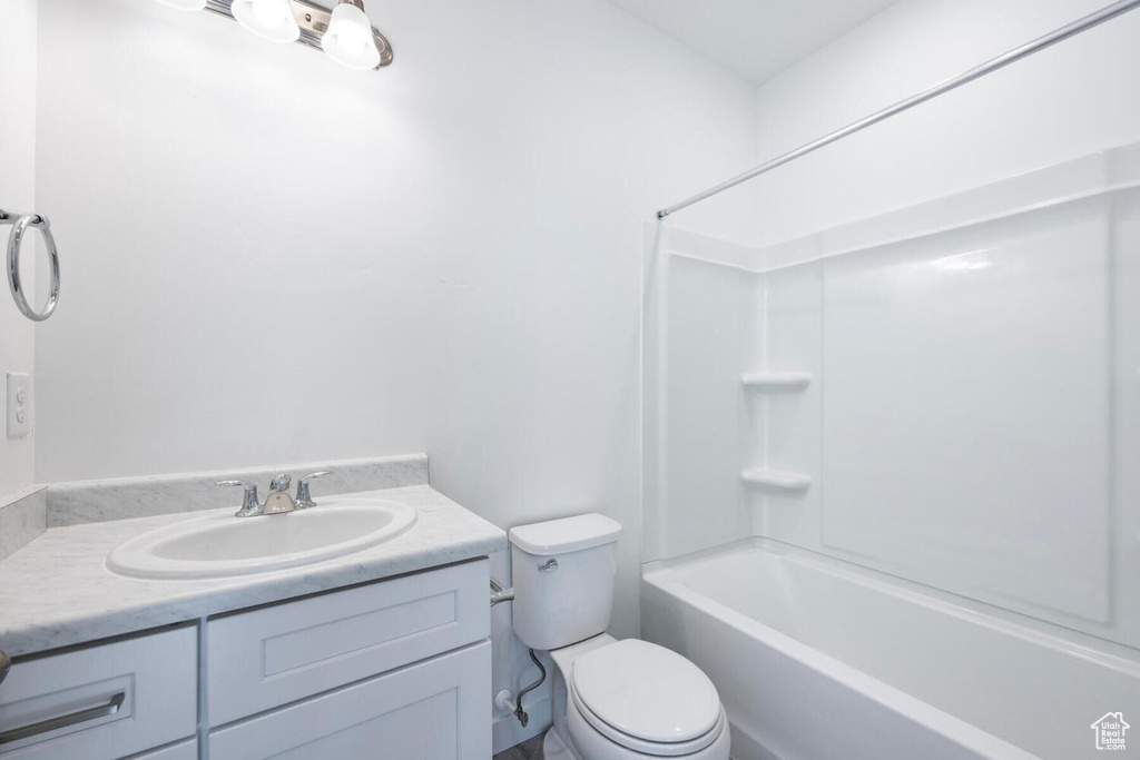 Full bathroom featuring shower / bathtub combination, toilet, and vanity