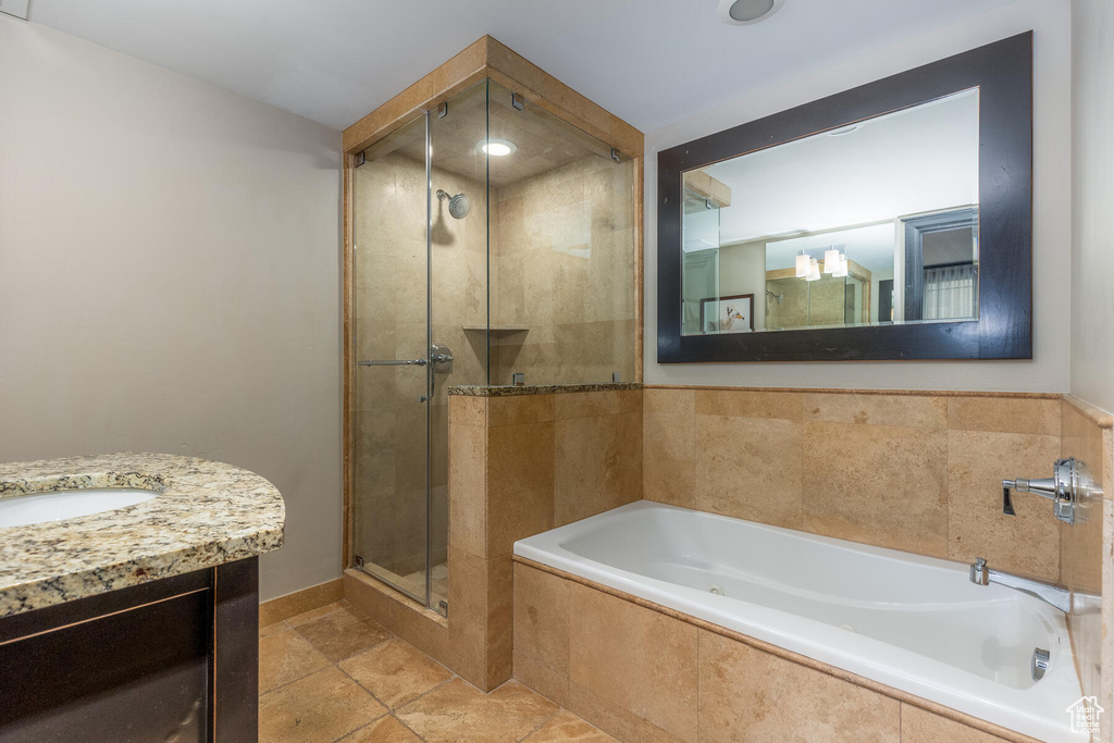 Bathroom with vanity, tile floors, and separate shower and tub
