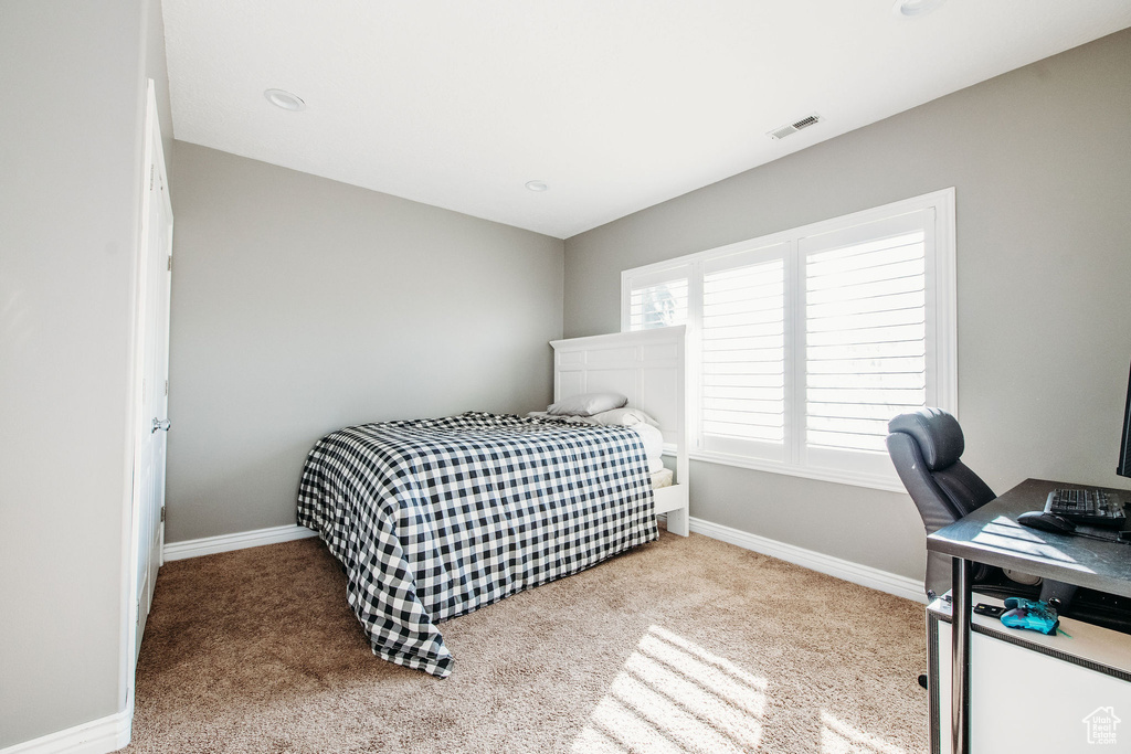 Bedroom with light colored carpet