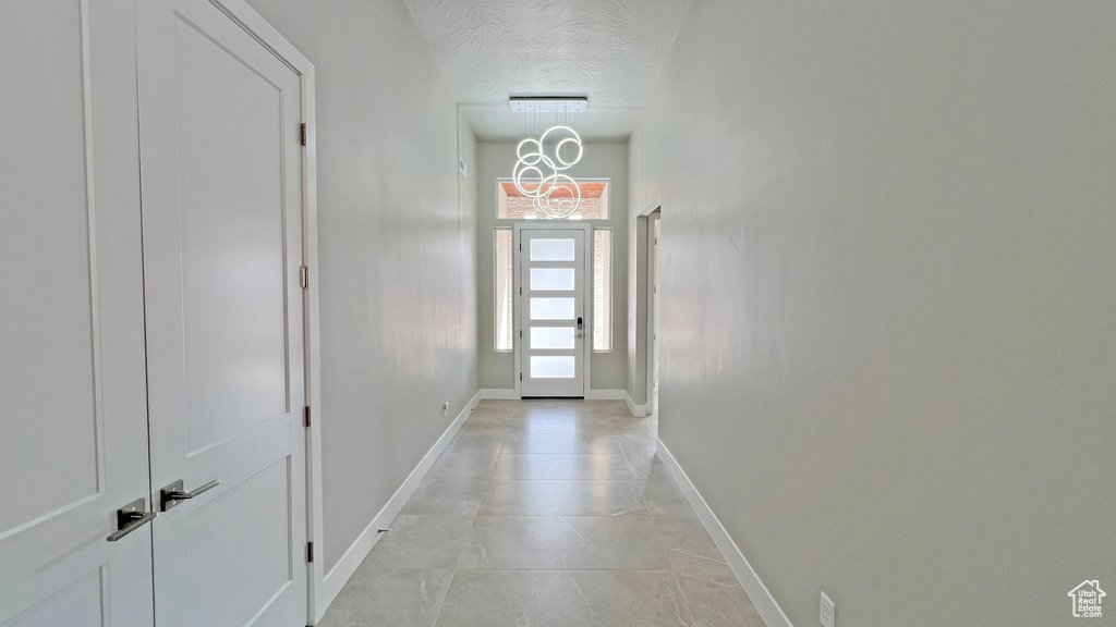 Entryway with light tile floors and a textured ceiling