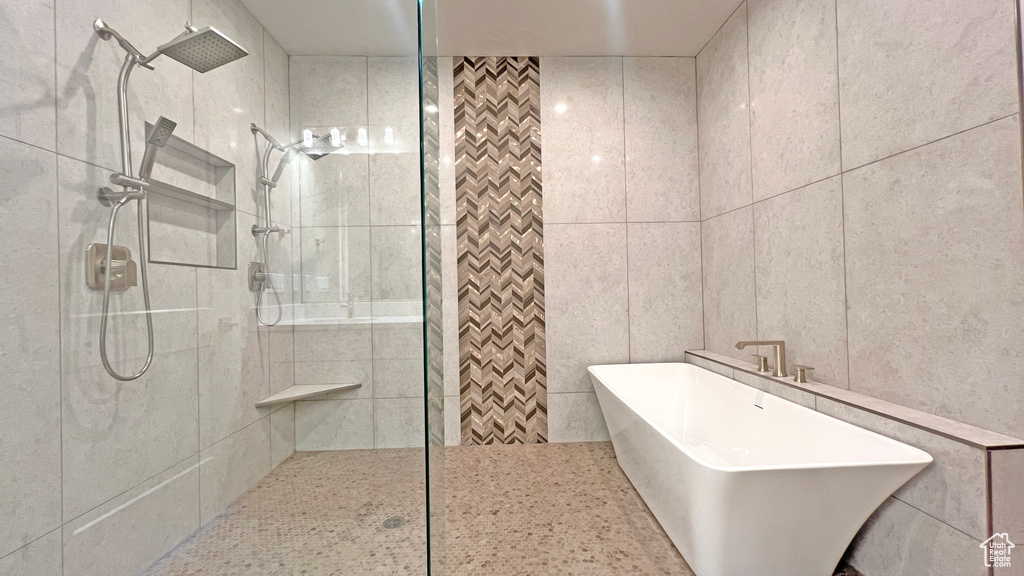 Bathroom with a tile shower and tile walls