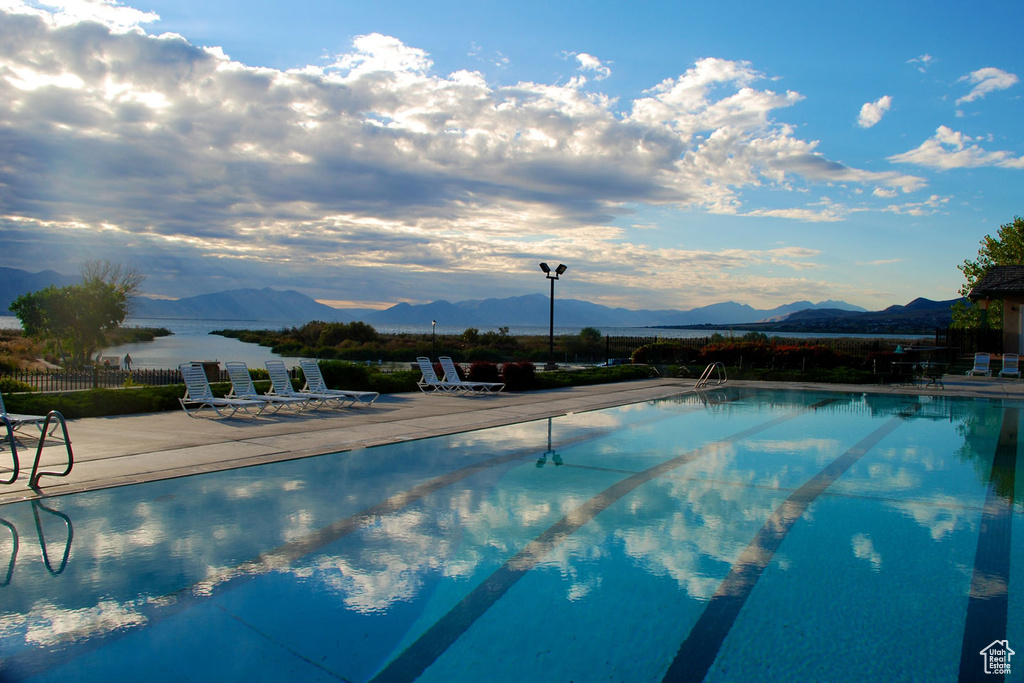 View of swimming pool with a mountain view and a patio