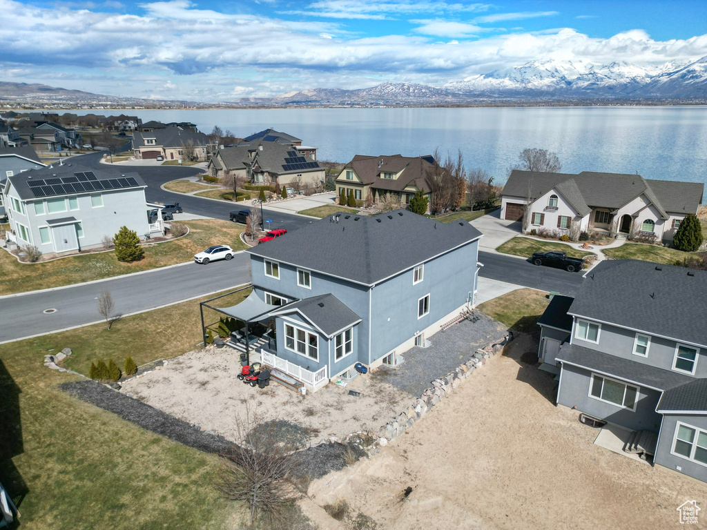 Birds eye view of property featuring a water and mountain view