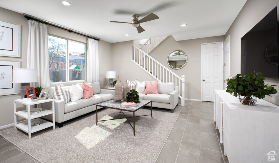 Tiled living room featuring ceiling fan
