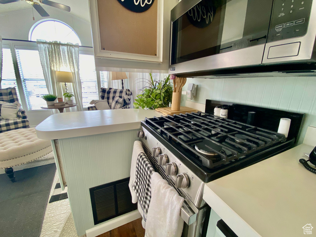 Kitchen featuring ceiling fan and gas range oven