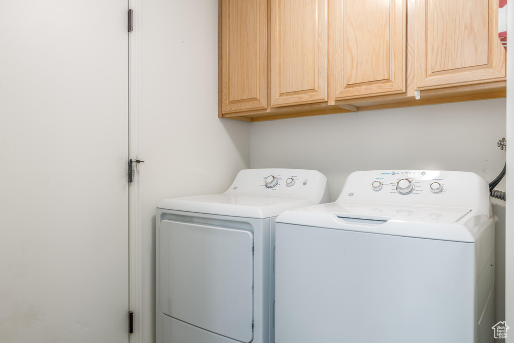 Clothes washing area with washing machine and clothes dryer and cabinets