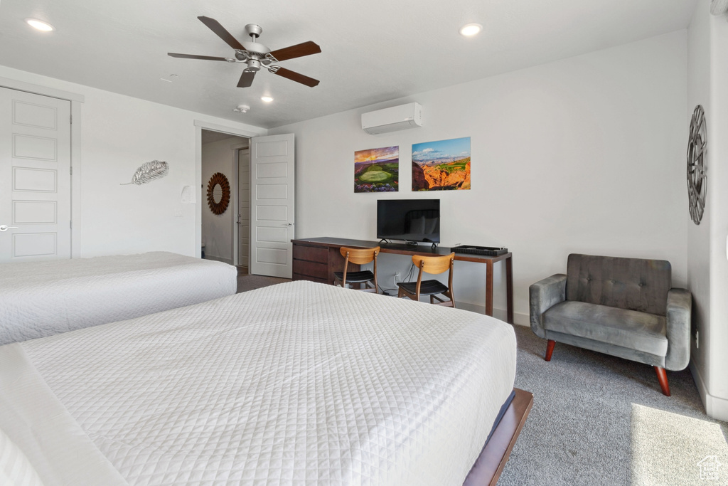 Carpeted bedroom with a wall mounted AC and ceiling fan