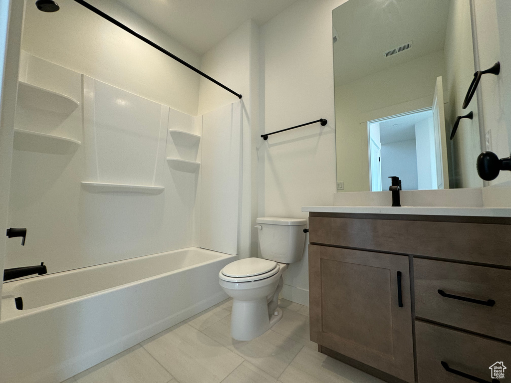Full bathroom with shower / tub combination, tile floors, toilet, and vanity