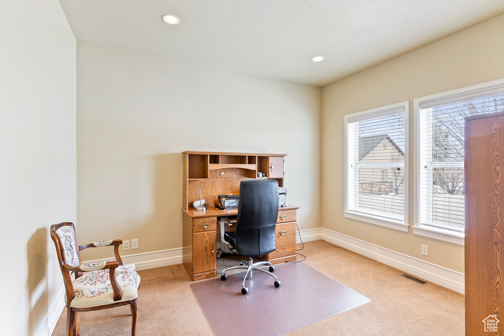 Office area with light colored carpet