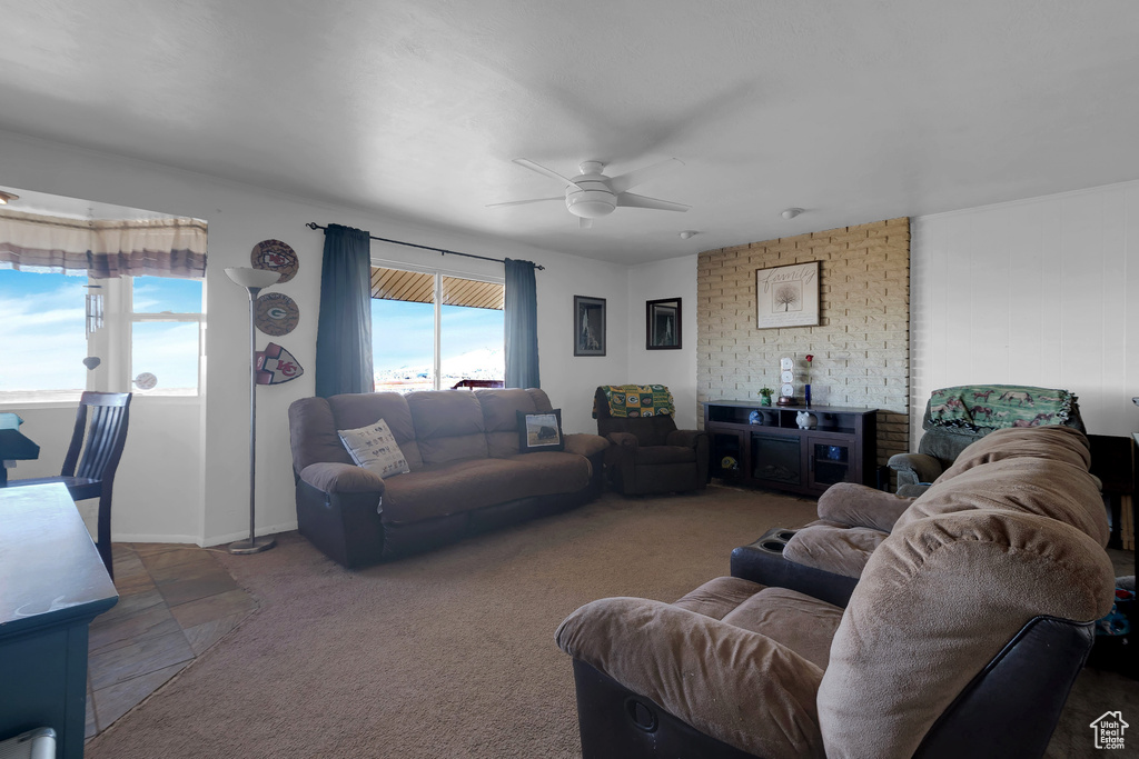 Living room featuring dark carpet and ceiling fan
