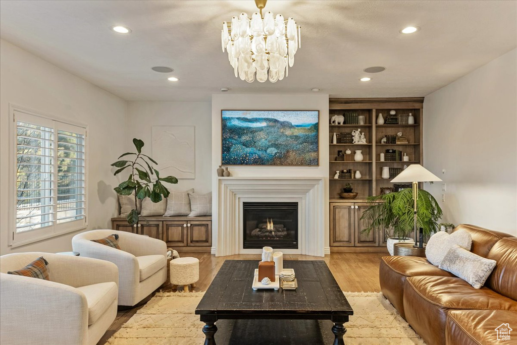 Living room featuring a notable chandelier and light hardwood / wood-style floors