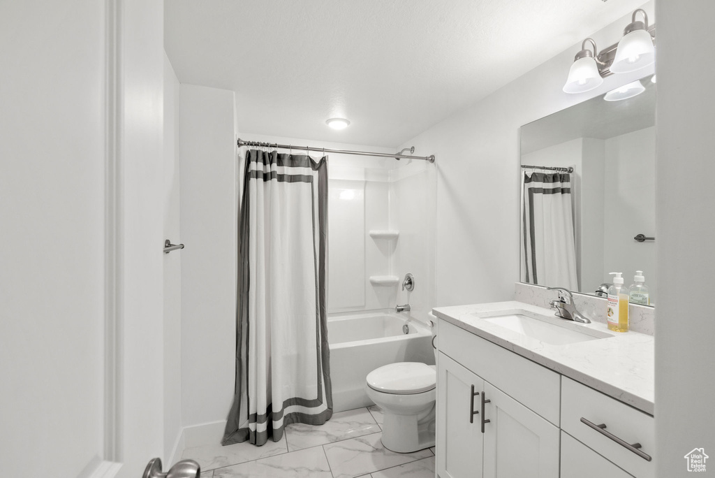 Full bathroom featuring vanity, toilet, tile floors, and shower / tub combo with curtain