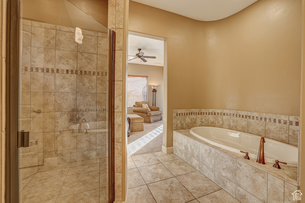 Bathroom featuring tile floors, separate shower and tub, and ceiling fan