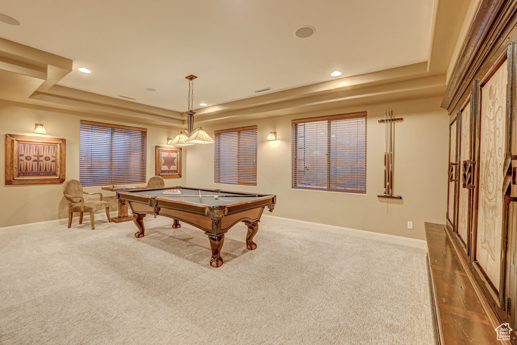 Recreation room with dark colored carpet, a raised ceiling, and pool table