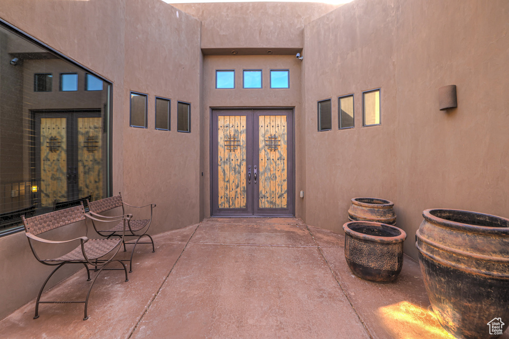 View of exterior entry with french doors and a patio area