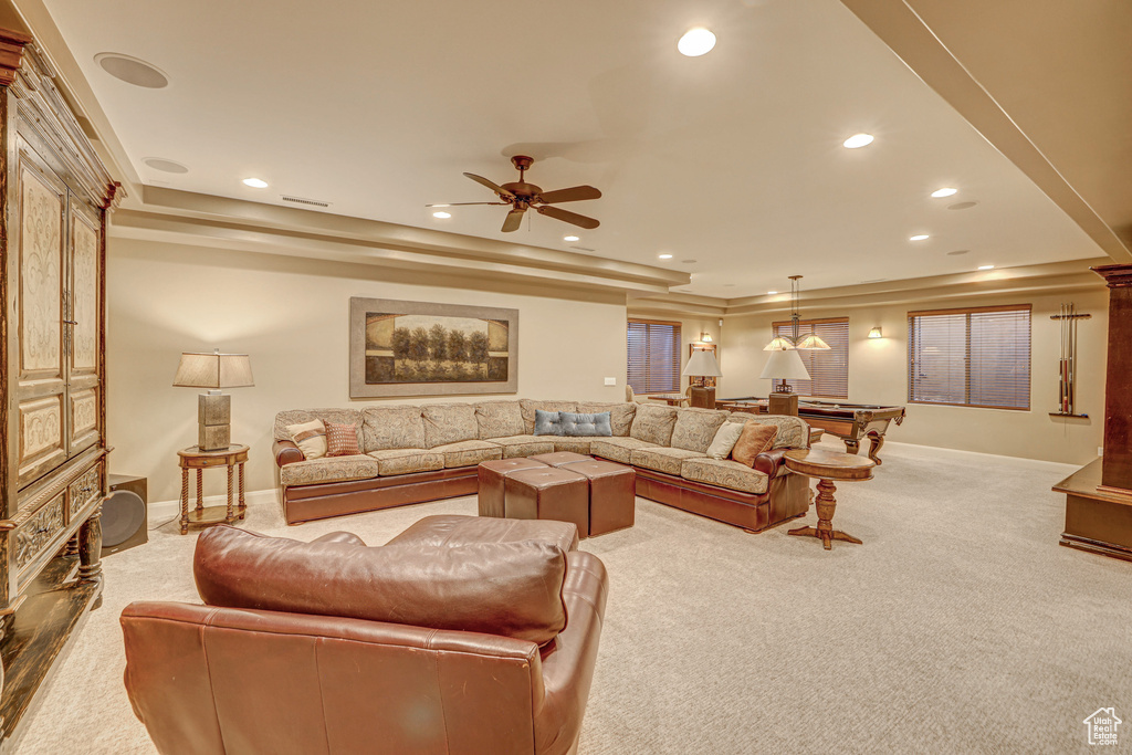 Carpeted living room featuring a tray ceiling, billiards, and ceiling fan