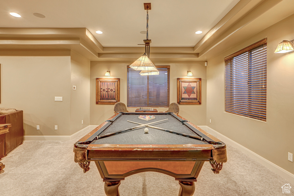 Game room with a tray ceiling, billiards, and light carpet