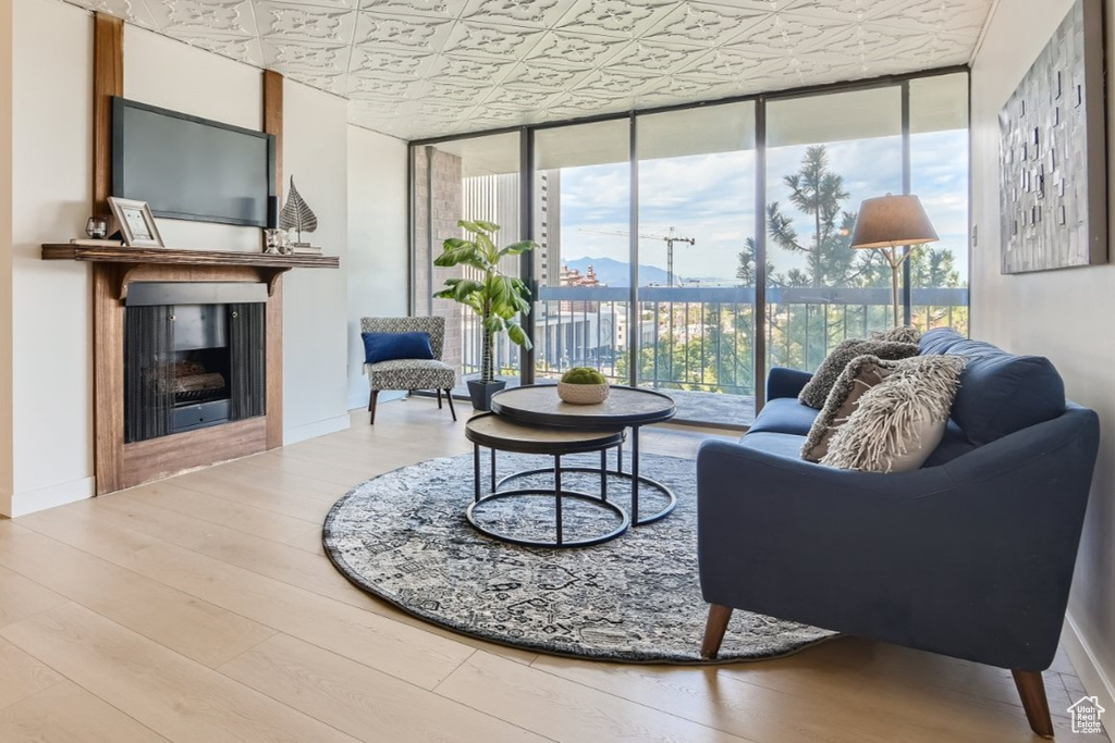 Living room featuring light hardwood / wood-style floors and floor to ceiling windows