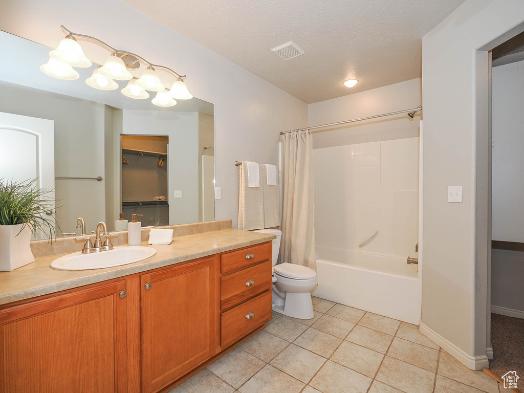 Full bathroom featuring vanity, tile flooring, shower / bath combination with curtain, and toilet