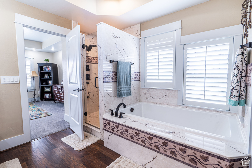 Bathroom with hardwood / wood-style flooring and plus walk in shower