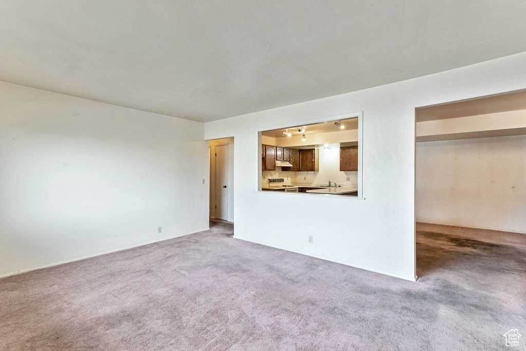 Unfurnished living room featuring carpet floors