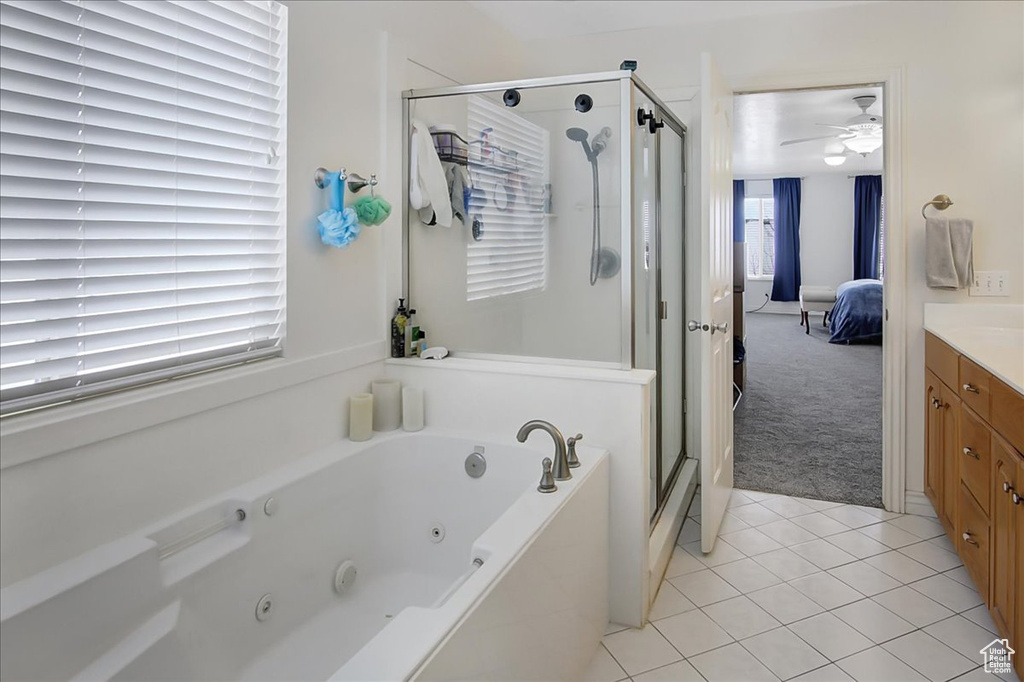 Bathroom with vanity, tile floors, plus walk in shower, and ceiling fan