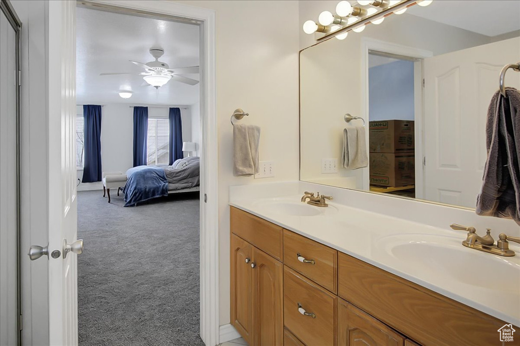 Bathroom featuring double vanity and ceiling fan