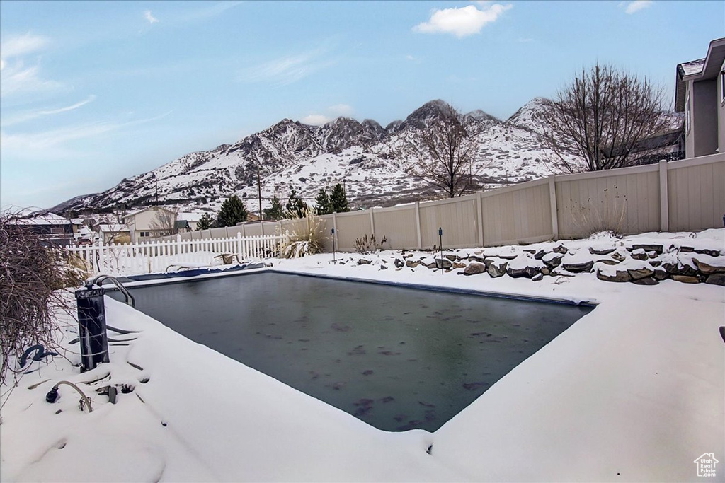 Snow covered pool with a mountain view