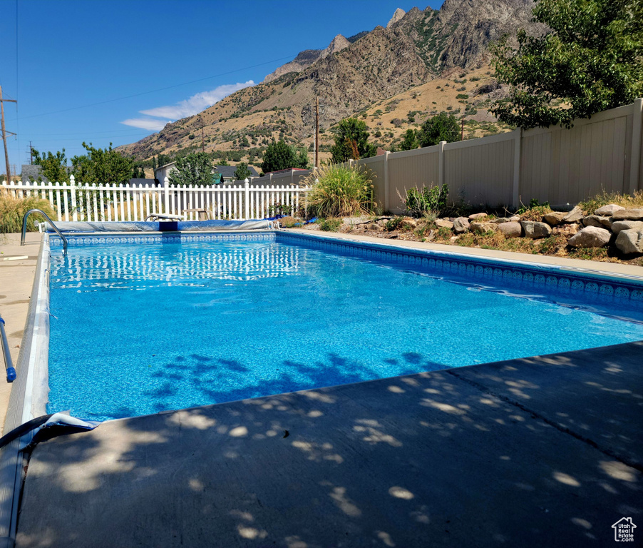 View of pool featuring a mountain view and a diving board