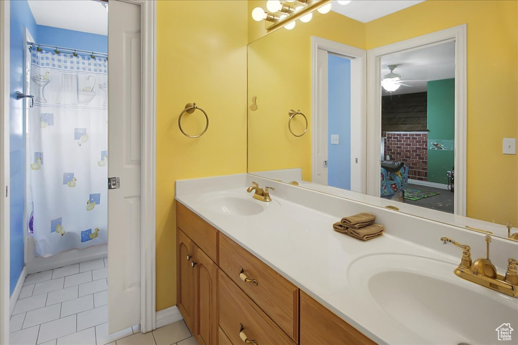 Bathroom featuring tile flooring, dual vanity, and ceiling fan