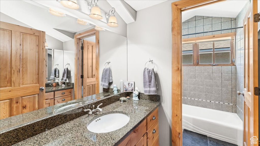 Bathroom with vaulted ceiling and vanity