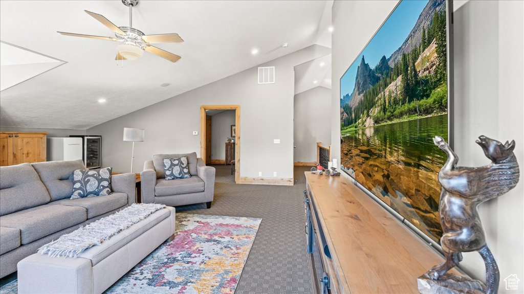 Carpeted living room featuring lofted ceiling and ceiling fan
