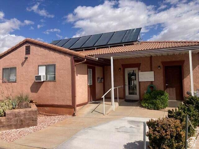 View of front of home featuring solar panels