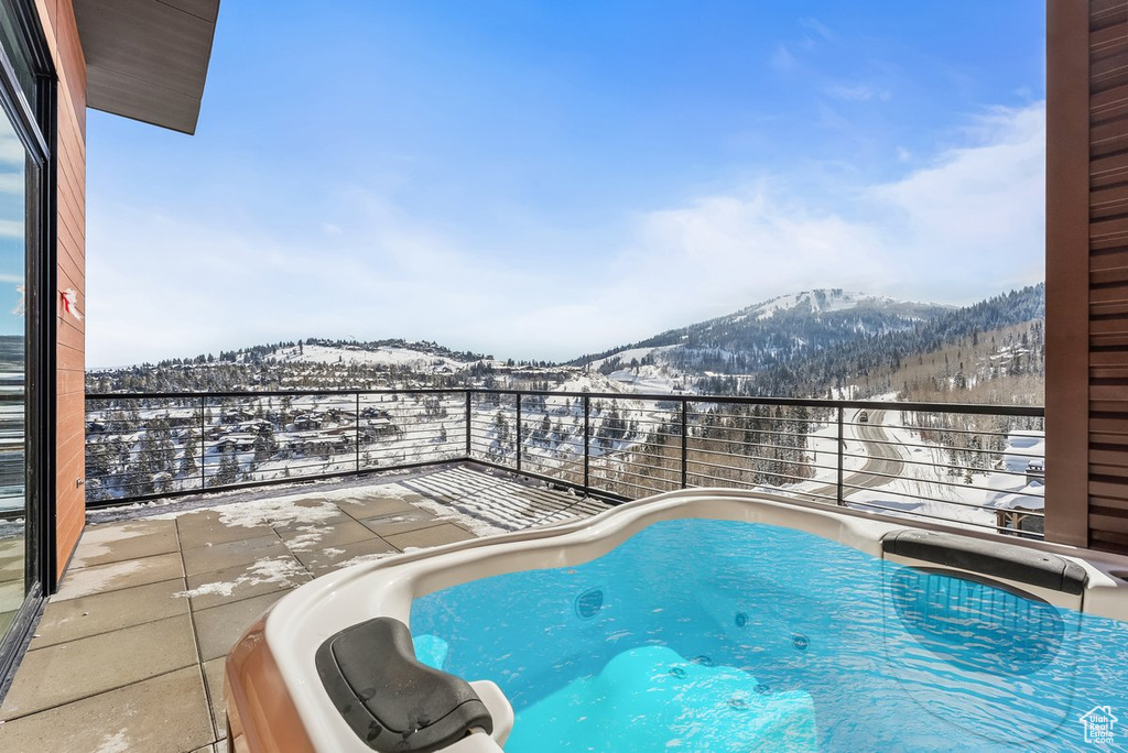 Snow covered pool with a mountain view