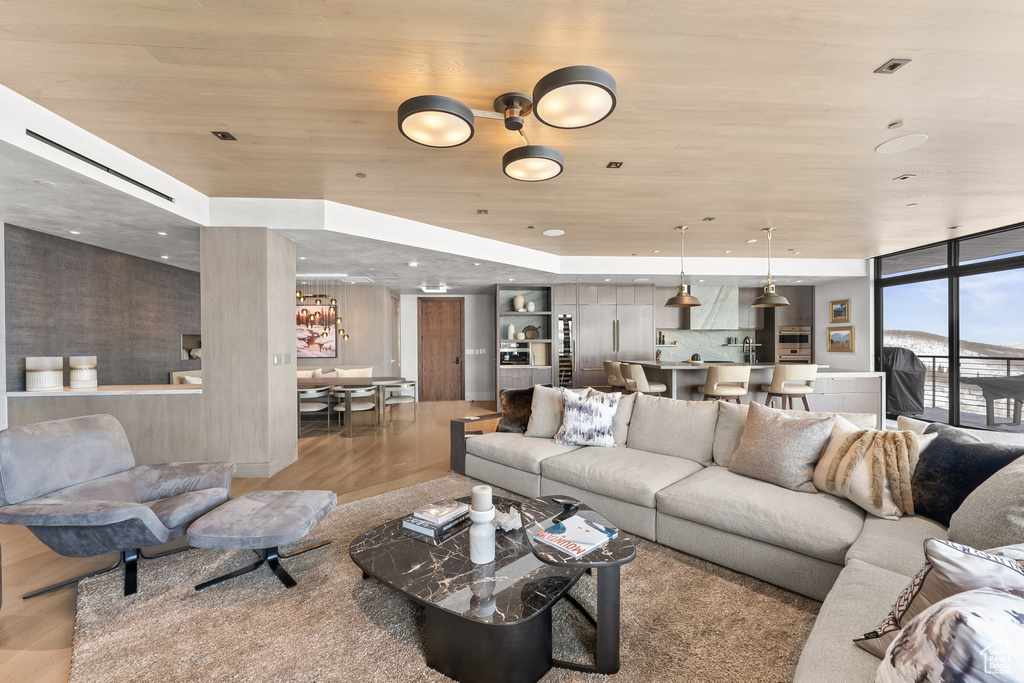 Living room featuring light hardwood / wood-style flooring and wood ceiling