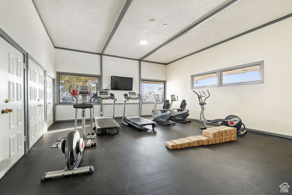 Gym with plenty of natural light and a textured ceiling