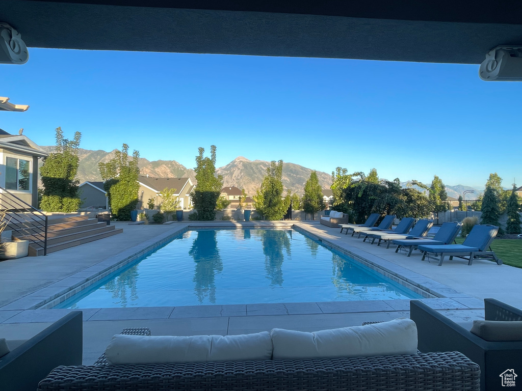 View of pool featuring an outdoor living space, a patio area, and a mountain view