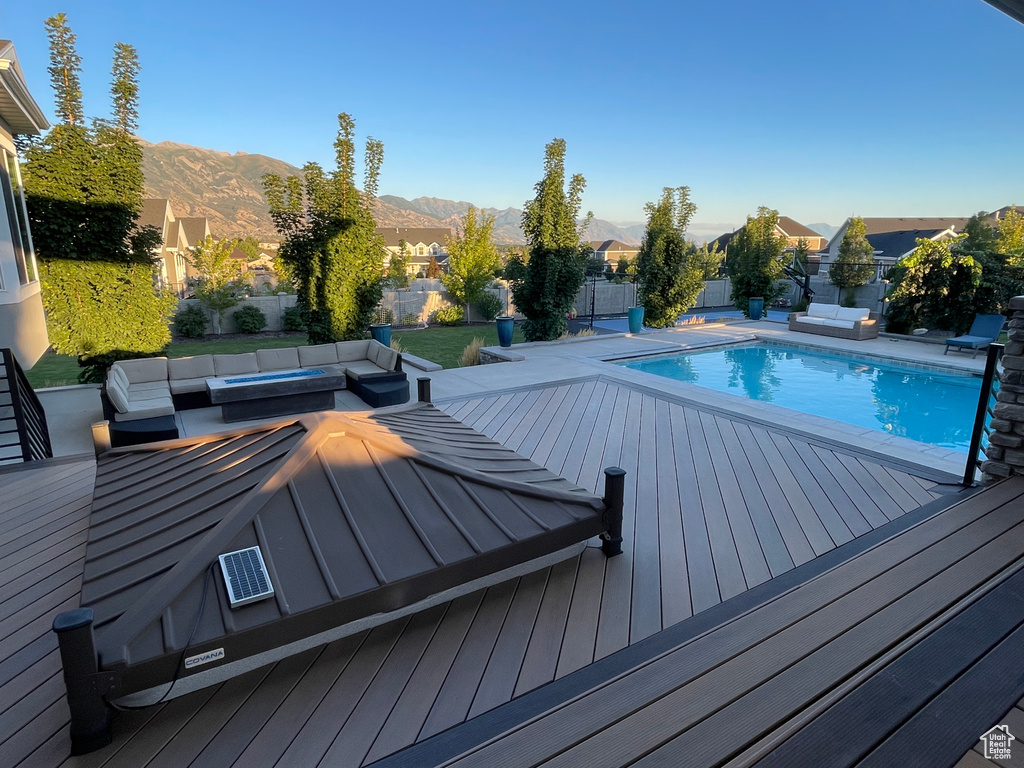 View of pool featuring a deck with mountain view and an outdoor hangout area