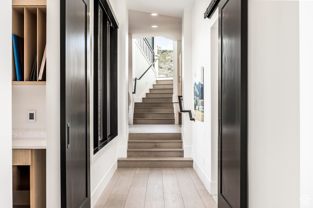 Stairs featuring light hardwood / wood-style floors