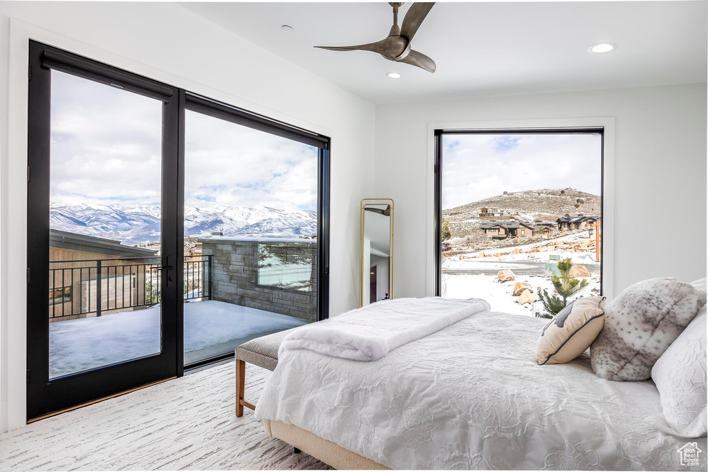 Bedroom with access to outside, a mountain view, and ceiling fan