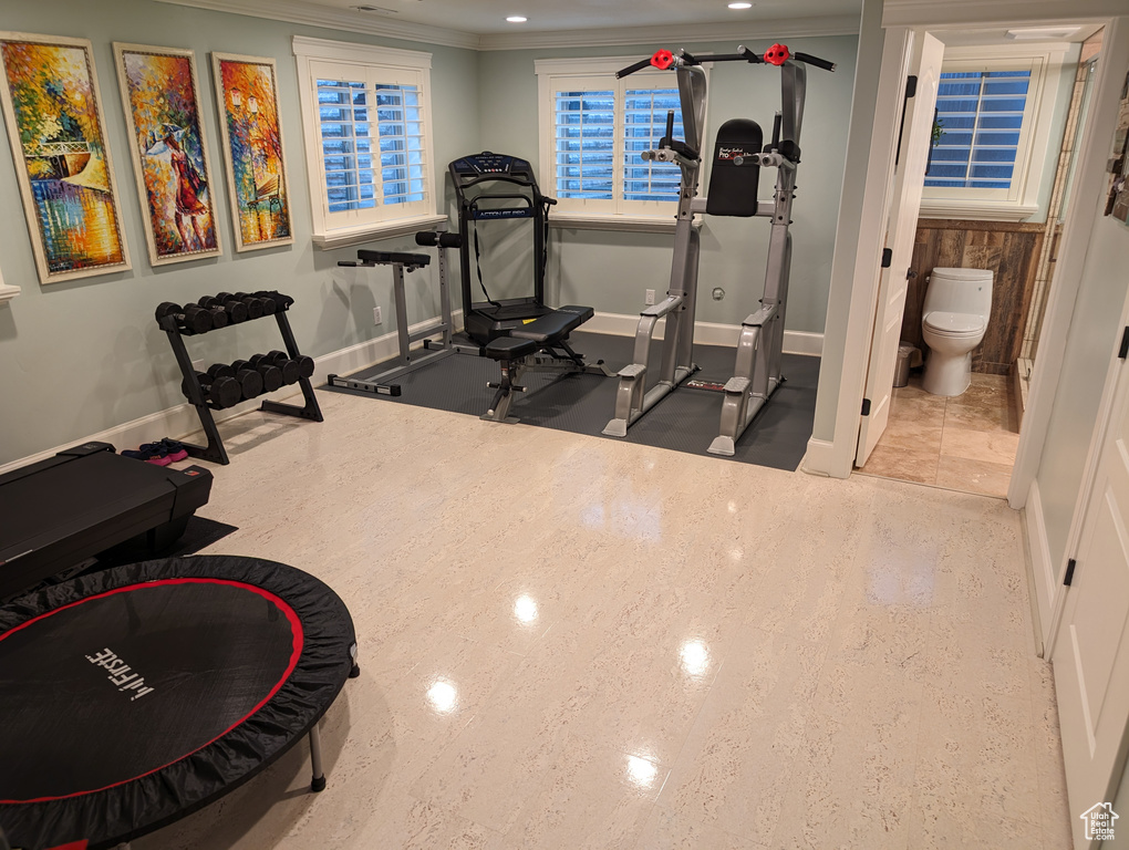 Exercise room featuring crown molding and tile floors