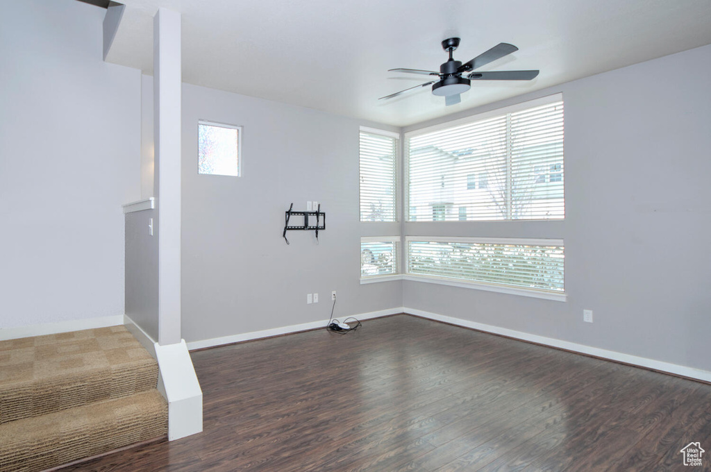 Interior space with dark wood-type flooring and ceiling fan