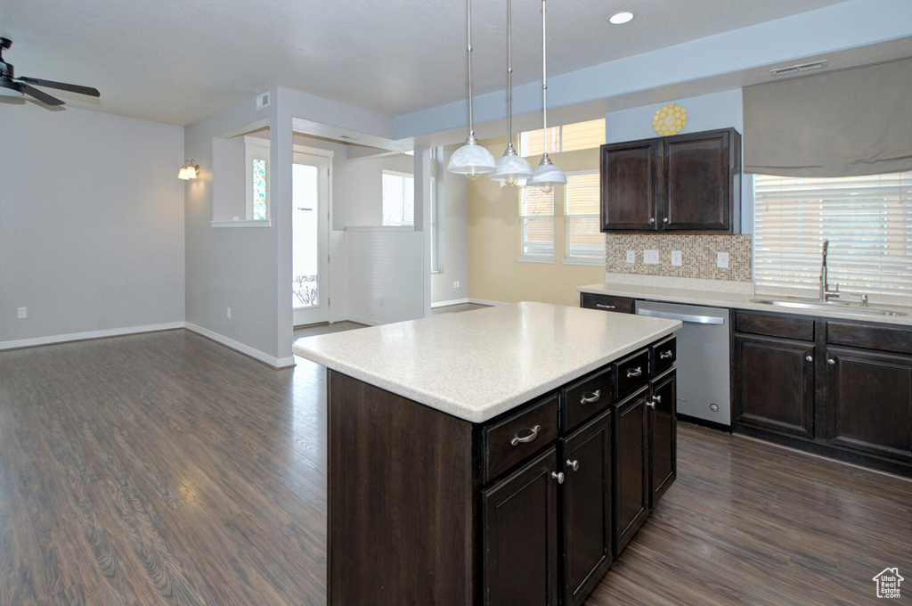 Kitchen featuring sink, pendant lighting, dark hardwood / wood-style flooring, dishwasher, and ceiling fan